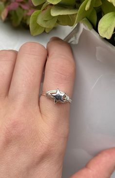 This star ring is perfect for you or any one on your shopping list. It makes an adorable addition to any outfit and a special gift for a star in your life.  Stone: Hematite Star Stone Size: Extra Small, 8mm Wire: Silver-plated  Available in whole and half US ring sizes 4 - 13. To extend the wear of your ring, it is best to keep it out of water. All Sparkle By Sharon jewelry arrives beautifully gift wrapped. Celestial Star-shaped Midi Rings As Gift, Star Charm Ring Jewelry Gift, Cute Silver Star Jewelry, Minimalist Star-shaped Midi Rings As Gift, Minimalist Star-shaped Midi Rings For Gifts, Handmade Star-shaped Promise Ring, Nickel-free Star-shaped Promise Ring, Adjustable Star Midi Rings For Promise, Adjustable Star-shaped Midi Rings As Gift