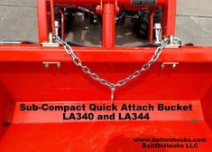 the back end of a red truck with chains on it