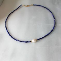 Natural Lapis Necklace for Women, Birthday Gifts for HerStunning and chic this beaded lapis lazuli necklace is the perfect everyday necklace or gift. Lapis is know as the friendship stone!•Gorgeous, genuine and natural 3mm lapis lazuli beaded by hand with freshwater pearl•Adorned with 14kt gold filled accents Water friendly Adjustable Single Strand Lapis Lazuli Beaded Necklace, Adjustable Single Strand Lapis Lazuli Necklace, Blue Lapis Lazuli Pearl Necklace Gift, Lapis Lazuli Beaded Necklaces For Gift, Single Strand Lapis Lazuli Beaded Necklace As Gift, Lapis Lazuli Beaded Necklace With Faceted Beads For Gift, Lapis Lazuli Faceted Beads Jewelry For Gift, Lapis Lazuli Jewelry With Faceted Beads For Gift, Faceted Lapis Lazuli Beads Jewelry For Gift