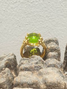 This is gold plated brass peridot ring. A designer handmade ring. It has a design of a coral, holding a green peridot gem. It could be an alternative engagement ring, or a great gift for a loving one. - 14 karat Gold plated brass - Round peridot gem - Free shipping worldwide - Sent in a gift box If you would like to see other rings I have made, please follow this link: https://www.etsy.com/il-en/shop/TamyZurTachshit?ref=seller-platform-mcnav&section_id=17271018 If you would like to go back t Lime Green Gemstone Ring Jewelry, Unique Round Peridot Jewelry, Unique Peridot Jewelry, Lime Green Gemstone Ring, Peridot Ring Jewelry, Lime Green Peridot Ring, Green Fusion Rings For Formal Occasions, Elegant Lime Green Ring For Gift, Elegant Lime Green Rings For Gift