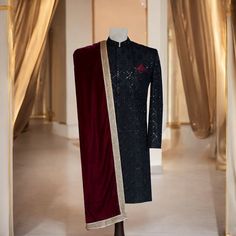 Make a statement on your big day with this ravishing black sherwani, accentuated with fine workmanship. This sherwani is aggrandized with minute handcrafted details in black and maroon, reflecting sophistication. This maroon shawl is made of velvet fabric and is accented with a golden border to give a rich, regal look. Key Features of this black designer sherwani: Premium fabric used to craft this black sherwani with intricate hand embroidery Maroon velvet shawl with golden border to add that to Traditional Black Kurta For Groom, Traditional Drape Black Kurta For Groom, Black Dabka Sherwani For Groom, Black Sherwani For Groom On Eid, Black Traditional Wear With Resham Embroidery For Groom, Black Traditional Wear With Resham Embroidery For Wedding, Black Bandhgala For Festivals, Black Sherwani With Dabka For Festivals, Black Kurta For Groom Eid Occasion