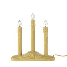 three candles are sitting on top of each other in the shape of a candle holder