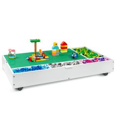 a toy table with legos and toys on it