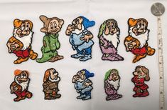 seven dwarfs embroidered onto a white cloth