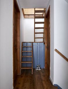 an empty room with stairs leading up to the loft