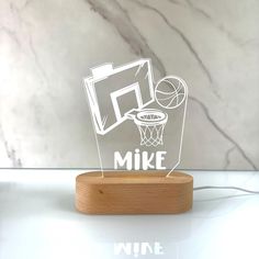 an acrylic cutout of a basketball hoop with the word mike on it