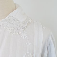 "A late Edwardian white dress with embroidery all over (front, back, and on sleeves) that feels incredibly modern for a piece 110+ years old. ERA: 1910s LABEL: no label MATERIAL: feels like fine linen or cotton and lace TAG SIZE: none FITS LIKE: S MEASUREMENTS: Length: 51\" Sleeve length: 21.25\" Shoulders: 17\" Shoulder to waist: 17\" Bust: 37\" Waist: 28\" Hips: 44\" (Note: measured lying flat and doubled, where necessary) DETAILS: Crew neckline; attached embroidered vest-style fabric over bod White Elegant Victorian Dress With Broderie Anglaise, White Broderie Anglaise Victorian Wedding Dress, White Victorian Wedding Dress With Broderie Anglaise, Vintage Victorian Dress With Broderie Anglaise For Wedding, Vintage Victorian Wedding Dress With Broderie Anglaise, Regency Style Wedding Dress With Broderie Anglaise, Elegant Victorian Dress With Broderie Anglaise For Wedding, Elegant Victorian Wedding Dress With Broderie Anglaise, Embroidered Linen Dress