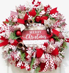 a christmas wreath with red and white bows