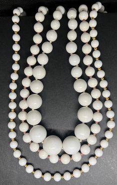 Vintage white colored necklace, vintage beaded necklaces, vintage necklace set, Monet necklace, vintage necklace, pre owned jewelry. Set of three white beaded necklaces. I believe they were made in the early 2000s. One branded by Monet. Two necklaces 24 inches long and the other 22 inches.   All jewelry purchases come beautifully gift wrapped at no additional cost. Complementary thank you goodie with each purchase as a token of our appreciation 1. Avoid Chemicals: Remove jewelry before using hou Handmade Vintage White Necklace, Vintage Pearl White Round Bead Necklaces, Vintage Pearl White Necklaces With Round Beads, Vintage White Single Strand Beaded Necklaces, Vintage White Single Strand Beaded Necklace, Vintage Cream Necklace With Round Beads, Vintage White Necklaces With Large Beads, Vintage Cream Necklaces With Round Beads, Vintage White Single Strand Necklace