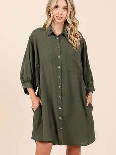 AIRFLOW WOVEN FABRIC - COLLARED - SINGLE CHEST POCKET - BUTTON DOWN FRONT - 3/4 LENGTH DOLMAN BALLOON SLEEVES WITH BUTTON CUFF - SIDE POCKETS - LOOSE FIT - MINI LENGTH - CURVED HEM Green Long Sleeve Shirt Dress With Pockets, Green Relaxed Fit Long Sleeve Shirt Dress, Green Long Sleeve Relaxed Fit Shirt Dress, Green Long Sleeve Shirt Dress With Button Closure, Casual Shirt Dress With 3/4 Roll-up Sleeves, Oversized Long Sleeve Green Shirt Dress, Oversized Green Long Sleeve Shirt Dress, Green Button-up Shirt Dress With Button Cuffs, Spring 3/4 Sleeve Relaxed Fit Shirt Dress