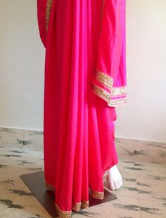 "Gorgeous glowing pink semi silk saree with a beautiful stone work border and silk unstitched blouse in blue silk brocade. The blue brocade is simply stunning when paired with the hot pink saree. Saree length 5.5 meters Blouse fabric 1 meter 44\" wide Saree ships in 2-3 days of payment.Shipping time is 4-5 days with tracking. We also offer blouse and petticoat stitching for saree as additional services. Please convo me if you need help or have any questions." Pink Raw Silk Pre-draped Saree With Resham Embroidery, Designer Pink Pre-draped Saree With Zari Work, Festive Pink Dola Silk Blouse Piece, Pink Raw Silk Saree With Resham Embroidery, Pink Pre-draped Saree In Raw Silk With Resham Embroidery, Pink Anarkali Blouse Piece With Resham Embroidery, Pink Pre-draped Saree With Resham Embroidery In Chinon, Pink Raw Silk Pre-draped Saree With Dupatta, Traditional Pink Pre-draped Saree With Embroidered Border