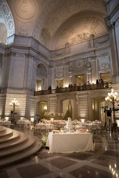 a banquet hall with tables and chandeliers