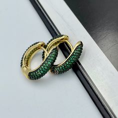 These beautiful and trendy emerald green huggie hoop earrings will make an excellent gift for yourself or friends. 18K real gold plated over brass, emerald green colored Cubic Zirconia. Measurements: Outer diameter - 17 mm Inner diameter - 10 mm These earrings would be a PERFECT GIFT for you and your family and friends! Our jewelry comes beautifully packaged in a gift box!   Click here to see more Modern Everyday Earrings: https://etsy.me/2UJldl1 Thank you for your visit! Emerald Green CZ Huggie Cheap Statement Green Hoop Earrings, Elegant Green Huggie Jewelry, Small Hoop Green Earrings For May Birthstone, Elegant Green Hoop Earrings, Single Green Round Earring, Green Single Round Earring, Green Hoop Jewelry With Matching Earrings, Green Huggie Earrings With Matching Set, Green Small Hoop Huggie Earrings For May Birthstone