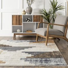 a living room with a chair, bookcase and potted plant