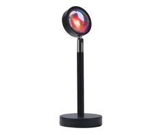 a black stand with a red light on it and a round object in the center