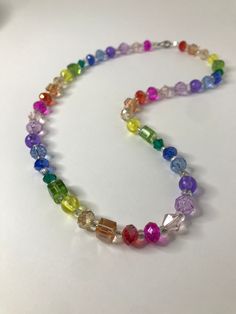 A rainbow of a necklace to brighten your life. The details are: - Rainbow - No more than 46 cm in length  - Nonadjustable - Made with glass and plastic beads - Only one of its kind! These elegant jewelry pieces consist of various glass bead creations with stainless steel, hematite, and other materials.  Want to see more similar creations? Visit https://www.etsy.com/people/ck0raz5mun8061t9?ref=hdr_user_menu-profile for more! Adjustable Rainbow Crystal Necklace With Faceted Beads, Rainbow Faceted Beads Necklace For Gift, Multicolor Glass Beaded Crystal Necklaces, Multicolor Glass Crystal Necklace With Colorful Beads, Multicolor Glass Beaded Crystal Necklace, Adjustable Rainbow Glass Necklaces, Adjustable Rainbow Glass Necklace, Adjustable Rainbow Necklace With Colorful Beads, Adjustable Crystal Necklaces With Colorful Glass Beads