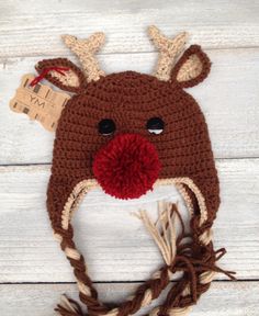 a crocheted deer hat with antlers on it's ears and nose