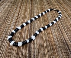 "Black and White Puka shell Necklace. Handmade with white seashell and black wooden beads 17\" Inches Around the neck Handmade Design. Necklace is Unisex Fits Most Sizes FAST SHIPPING! *First Class Mail* Visit my Etsy Shop to see more Designs! Handmade Earrings, Puka Shell Bracelets and Puka Shell Necklaces. Click here to see more designs: https://www.etsy.com/shop/FreedomLifeStyle" Black Beaded Necklace For Vacation, Black Wooden Beads Necklace For Beach, White Necklace With Black Beads For Beach, Black Round Bead Jewelry For Vacation, Black Round Beads Jewelry For Vacation, White Wooden Beads Necklace For Vacation, Black Round Bead Jewelry, Handmade Black Shell Necklaces, Adjustable Black Necklace For Vacation