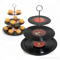 three tiered trays holding cupcakes and vinyl record records are shown in front of each other