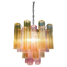 a multi - colored chandelier hanging from a chain