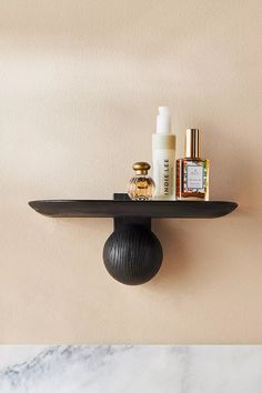 a shelf that has some bottles on top of it and other items sitting next to it