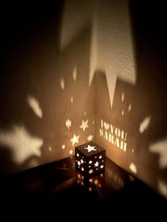 a candle that is sitting on top of a table with some lights in the background