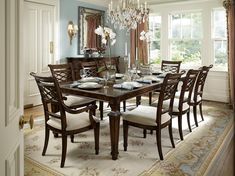 a dining room table with chairs and a chandelier