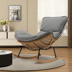 a wicker rocking chair and ottoman in a living room