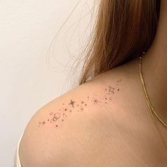 the back of a woman's shoulder with stars on it