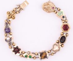 Lovely 14K yellow gold vintage slide bracelet with many different gemstones.  Diamond, ruby, seed pearl amethyst cameo, and more. 8 inches in length in the closed-clasped position.  16mm in width.  Slides are marked 14K  Guaranteed to please and ready to give. Antique Multi-stone Bracelet As Gift, Antique Multi-stone Bracelets As Gift, Antique Gold Multi-stone Jewelry, Antique Multi-stone Gold Jewelry, Heirloom Gemstone Bracelet Jewelry, Heirloom Gemstone Bracelet, Heirloom Collectible Bracelet Jewelry, Heirloom Bracelet Collectible Jewelry, Victorian Vintage Charm Bracelet