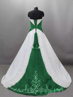 a green and white wedding gown on a mannequin