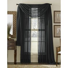 black sheer curtains hanging in front of a window