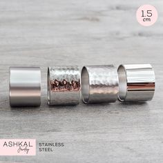 "Our High Quality Stainless Steel Rings are sturdy, tarnish-free and made to last a lifetime. All our products are made by us with great care. Made in the USA with globally sourced high quality materials. Thoughtfully packaged with recyclable and biodegradable materials. Add a little edge & glare to any outfit with these simple and quality tube rings. You can choose from 5 different textures. They're cut from high-grade stainless steel sheets, left plain or hammered and given various finishes. Steel Sheets, Biodegradable Materials, Wide Silver Ring, Simple Silver Jewelry, Hammered Ring, Wide Band Ring, Cuff Ring, Cuff Rings, Waterproof Jewelry