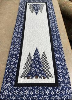 a quilted table runner with trees on it