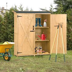 an outdoor storage shed with gardening tools in it