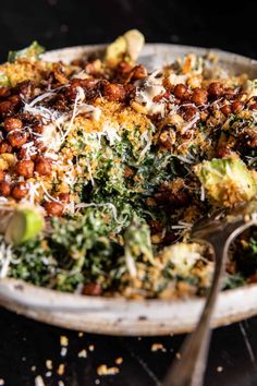 a bowl filled with lots of food on top of a table