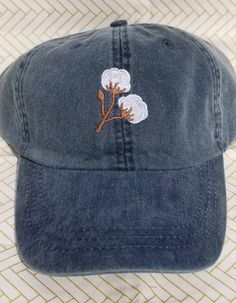 Cotton branches are in this season! Perfect for the southern belle trying to keep the sun and messy hair out of her face! Hat pictured is Navy. These hats are Adams brand. They are 100% cotton twill, garment washed and pigment dyed. These are a low profile with a mesh lining. The back has a tuck-away leather strap with a brass buckle. (seen in picture #4) Hat colors available in picture #2. NEW Spring/Summer hat colors available in picture #3. (Neon Pink, Neon Yellow, Neon Green, Tangerine) Cotton Brimmed Hat One Size Fits Most, Adjustable Cotton Brimmed Hat, Cotton Bucket Hat, One Size Fits Most, Adjustable Cotton Hats For Spring, Adjustable Cotton Spring Hats, Cotton Beach Baseball Cap, Trendy Cotton Hat With Curved Brim, Trendy Cotton Snapback Trucker Hat, Trendy Cotton Trucker Hat For Beach