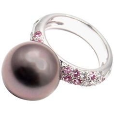 18k White Gold Diamond And Pink Sapphire With Large Tahitian Pearl Ring by Cartier. With1 Tahitian pearl 12.5mm 12 round brilliant cut diamonds VS1 clarity, E color total weight approx. .36ct 15 round pink sapphires. This ring comes with original Cartier box. Details: Ring Size: 4.5 US, Europe 48 Weight: 9.1 grams Width: 12.5mm Stamped Hallmarks: Cartier 750 48 Cartier 2001 N94708 *Free Shipping within the United States* YOUR PRICE: $4500 T1445tedd Sapphire White Gold Ring, Tahitian Pearl Ring, White Gold Sapphire Ring, Pink Sapphire Ring, Tahitian Pearls, Pearl Diamond, White Gold Ring, Black Pearl, Tahiti