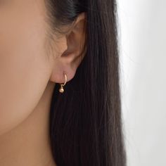 Sweet and dainty, these gold huggie earrings feature a polished round charm. Made of 14K gold filled materials, these earrings are tarnish-resistant, water-resistant, and hypoallergenic. Hoop measures 12mm in diameter while the charm measures 4mm in diameter. To put them on, don't pull the hoop apart, instead bend them towards opposite sides like shown in the photo. --------------------♥ PROMOS ♥-------------------- Want 10% off? Join the mailing list by visiting http://bit.ly/vedern . Just leav Small Hoop Earrings Gold, Small Earrings Gold, Gold Huggie Earrings, Simple Gold Earrings, Gold Huggies, Huggie Earrings Gold, Fancy Jewelry Necklace, Small Hoop Earrings, Hoop Earrings Gold