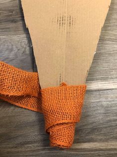 an orange cloth wrapped around a piece of cardboard