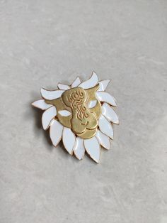 A perfect & stylish Gold Lion Head Brooch with White enameling. It's modern, it makes a statement, and it suits the bold personality. Details: Brass Metal Hypoallergenic White Enameling Closure: Pin *Care: Do not use perfumes or sanitizers around or on the jewelry. Clean it with a cotton cloth. **Gifting someone? Comes wrapped in eco-friendly wrapping paper with a beautiful handmade doodle card. (DM for reference) White Enamel Brooch Jewelry, White Enamel Brooches As Gifts, Formal White Enamel Pin Brooch, White Enamel Pin For Gift, Formal White Enamel Pin, Enamel Brooch Lapel Pin Gift, Silver Lapel Pin With Metal Pinmount Logo As Gift, Silver Lapel Pin With Metal Pinmount Logo For Gift, Metal Enameling