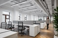 a woman walking through an open office space