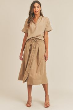 The Short Sleeve Top and Button-Down Midi Skirt Set delivers a stylish, coordinated look. The relaxed top pairs with an elegant button-down midi skirt for a classic touch. Versatile and easy to style, this set transitions effortlessly from day to night. Material composition: 70% tencel, 30% rayon Recommended sizing 2-4 S, 6 M, 8-10 L Product measurements: S:Bust 33-35 in, Waist 25-27 in, Hip 35-37 in M:Bust 35-38 in, Waist 27-30 in, Hip 37-40 in L:Bust 38-40 in, Waist 30-32 in, Hip 40-42 in Rayon Midi Skirt For Day Out, Midi Length Rayon Skirt For Day Out, Versatile Midi Length Skirt For Day Out, Chic Rayon Skirt For Daywear, Chic Daywear Rayon Skirt, Spring Midi Dress For Day Out, Casual Midi Skirt Made Of Rayon, Casual Midi Length Rayon Skirt, Chic Skirt With Buttons For Spring