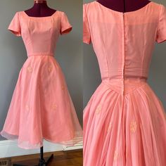 "Vintage 1950s coral pink cocktail party dress, with aaalllll the party in the back. A round neckline and waist in front, with piping detail and rose appliques. Soft floaty organza over a taffeta base. This dress boasts a GORGEOUS Basque waist with pleated detail in the back, with a dropped back neck. There is a metal Star zipper, and several hooks. Someone has sewn a stiff tulle crinoline into the dress by hand, and I have chosen to leave it as is. The crinoline hooks at the back, and gives great volume to the dress. The outer organza layer also has horse hair (a stiffening sewing strip, not animal product) onto the bottom hem for volume. Condition: excellent vintage condition. Some seam strain is seen on the back waist, but fairly minor. See last pic. Labels/tags:   Measurements: taken f 1950s Style Pink Wedding Dress, Fitted Pink Vintage Prom Dress, 1950s Style Pink Vintage Dress For Party, 1950s Style Pink Vintage Party Dress, 1950s Style Pink Dresses With Fitted Bodice, 1950s Style Pink Dress For Vintage Events, 1950s Style Pink Party Vintage Dress, 1950s Pink Vintage Wedding Dress, 1950s Style Pink Formal Dress