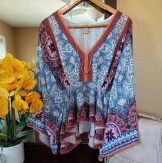 Nwot. All The Bohemian Vibes With This Gem. Colors Are Super Vivid. Deep V-Neck. Empire Waist With A Ruffle Hem. Sleeves Stop At Elbow And Flare Out. Looks Great With A Bralette, Distressed Shorts And Gold Accessories. Bust: 19-20 Inches (Approximate) Length: 23 Inches Shoulder To Hem Vibrant Print V-neck Top For Brunch, Bohemian Blue V-neck Tops, Bohemian Flowy V-neck Top, Multicolor Floral Print V-neck Peasant Top, Blue Vibrant Print V-neck Top, Flowy V-neck Peasant Top, Beach V-neck Peasant Top With Boho Print, Boho Print V-neck Peasant Top For Beach, Beach Boho Print V-neck Peasant Top