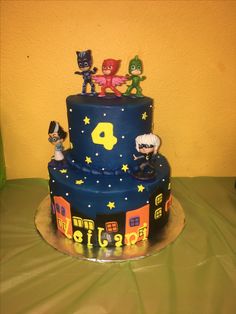 a birthday cake decorated with figurines on top