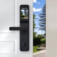 an electronic door lock is open on a white door with a driveway in the background