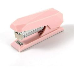 a pink stapler sitting on top of a white table