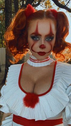 a woman dressed as a clown with red hair and makeup