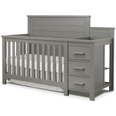 a baby crib with drawers and a changing table in the bottom drawer is shown